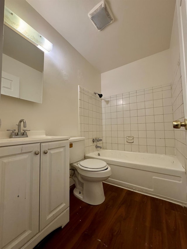 5972 Walerga Rd Unit 1, Sacramento, CA 95842 - full bath featuring wood finished floors, toilet, vanity, and washtub / shower combination