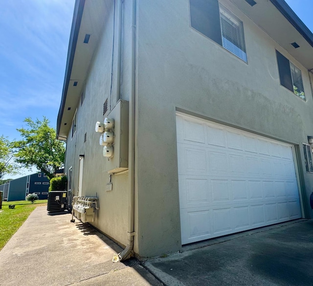 5972 Walerga Rd Unit 1, Sacramento, CA 95842 - view of side of home featuring a garage and stucco siding