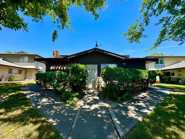 5972 Walerga Rd Unit 1, Sacramento, CA 95842 - view of front of home with a chimney, a front yard, and cooling unit