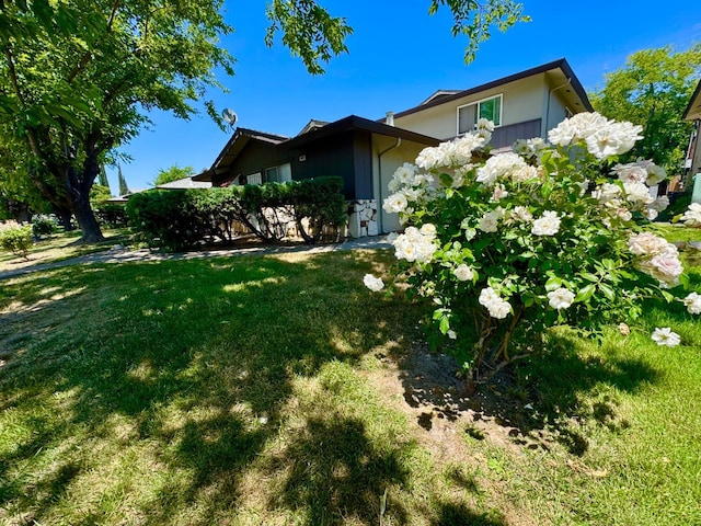 5972 Walerga Rd Unit 1, Sacramento, CA 95842 - view of home's exterior featuring a lawn