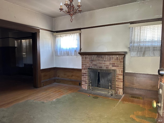 718 Monterey St, Vallejo, CA 94590 - unfurnished living room with a fireplace, wood finished floors, a chandelier, and wainscoting