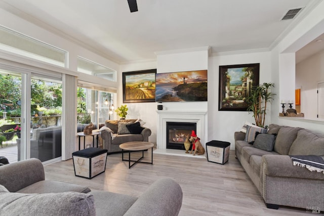 602 Summerset Dr, Rio Vista, CA 94571 - living room with a glass covered fireplace, crown molding, light wood finished floors, and ceiling fan