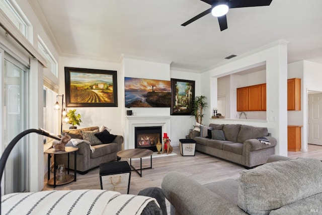 602 Summerset Dr, Rio Vista, CA 94571 - living area with a ceiling fan, light wood-style floors, a lit fireplace, and crown molding