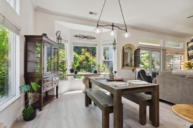 602 Summerset Dr, Rio Vista, CA 94571 - dining area featuring crown molding, light wood finished floors, plenty of natural light, and baseboards