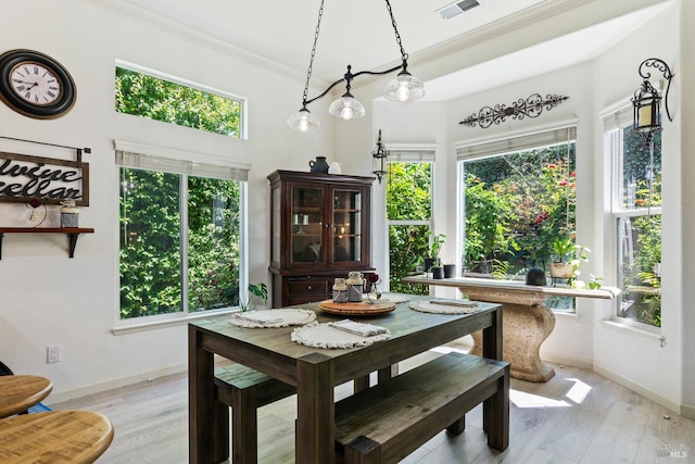 602 Summerset Dr, Rio Vista, CA 94571 - dining area with baseboards, ornamental molding, light wood finished floors, and a towering ceiling