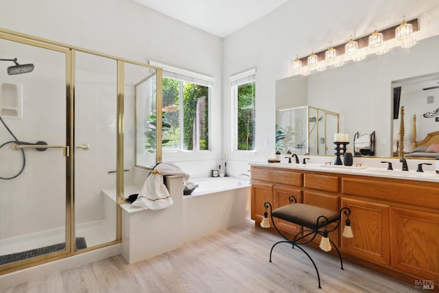 602 Summerset Dr, Rio Vista, CA 94571 - bathroom with a stall shower, double vanity, a bath, and wood finished floors