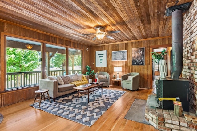 10520 Hwy 116, Forestville, CA 95436 - living area with a wood stove, wood ceiling, plenty of natural light, wood walls, and hardwood / wood-style flooring