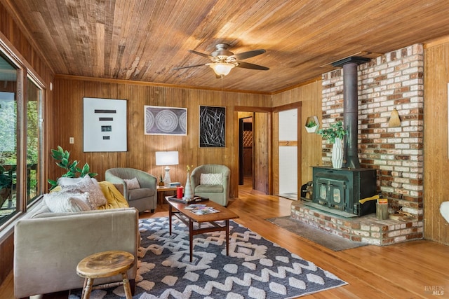 10520 Hwy 116, Forestville, CA 95436 - living room with wood ceiling, wooden walls, a wood stove, ceiling fan, and wood finished floors