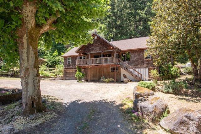10520 Hwy 116, Forestville, CA 95436 - view of front of house with stairway, dirt driveway, a garage, a shingled roof, and a deck