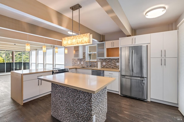 320 Via Casitas Unit 109, Greenbrae, CA 94904 - kitchen featuring appliances with stainless steel finishes, backsplash, a center island, a peninsula, and dark wood finished floors