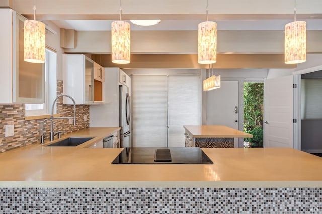 320 Via Casitas Unit 109, Greenbrae, CA 94904 - kitchen featuring appliances with stainless steel finishes, a sink, light countertops, decorative backsplash, and white cabinetry