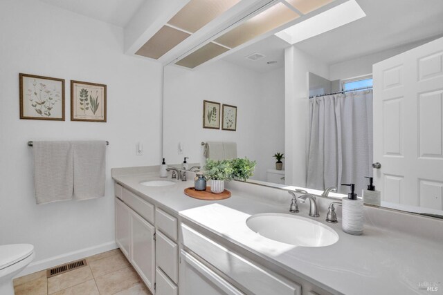 359 Wildrose Cir, Pinole, CA 94564 - bathroom with a skylight, toilet, double vanity, tile patterned floors, and baseboards