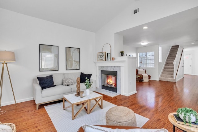 359 Wildrose Cir, Pinole, CA 94564 - living area featuring vaulted ceiling, a fireplace, light wood finished floors, stairway, and baseboards