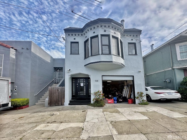108 Naglee Ave, San Francisco, CA 94112 - view of front facade featuring an attached garage, concrete driveway, and stucco siding