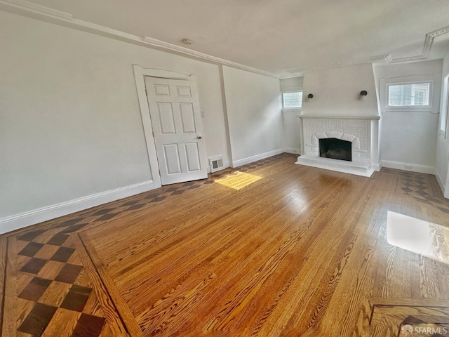 108 Naglee Ave, San Francisco, CA 94112 - unfurnished living room featuring a fireplace with raised hearth, baseboards, ornamental molding, and wood finished floors