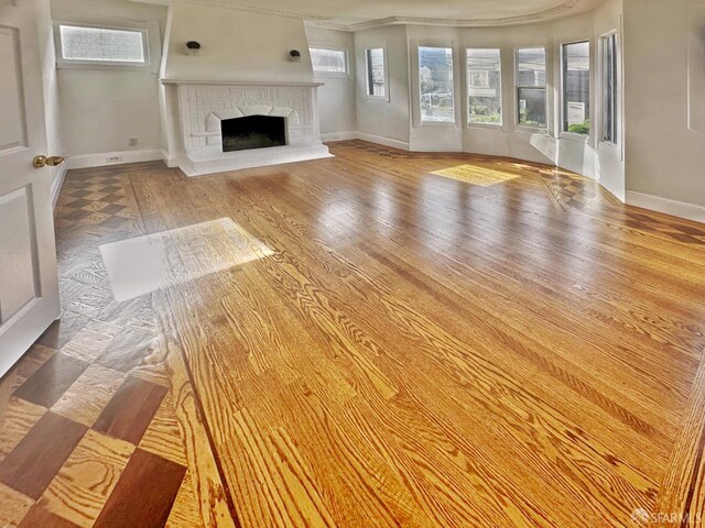 108 Naglee Ave, San Francisco, CA 94112 - unfurnished living room featuring baseboards, wood finished floors, a fireplace with raised hearth, and crown molding