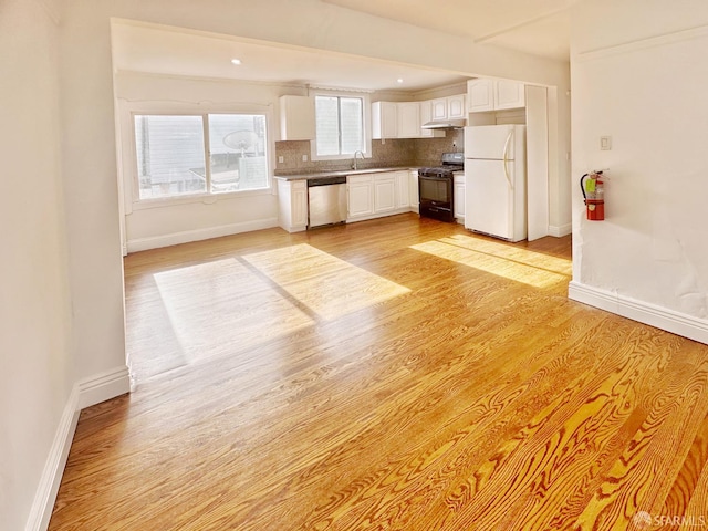 108 Naglee Ave, San Francisco, CA 94112 - kitchen featuring freestanding refrigerator, black gas range, stainless steel dishwasher, a sink, and white cabinetry