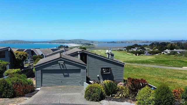 21199 Hummingbird Ct, Bodega Bay, CA 94923 - view of front of home featuring a water view, driveway, and a garage