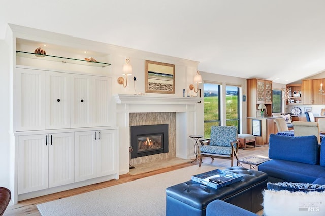21199 Hummingbird Ct, Bodega Bay, CA 94923 - living room with a tile fireplace, light wood-style flooring, and vaulted ceiling