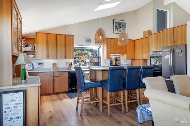 21199 Hummingbird Ct, Bodega Bay, CA 94923 - kitchen with high vaulted ceiling, a skylight, freestanding refrigerator, open shelves, and light countertops