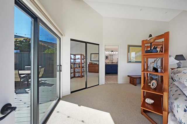 21199 Hummingbird Ct, Bodega Bay, CA 94923 - carpeted bedroom featuring access to outside, baseboards, ensuite bath, and high vaulted ceiling