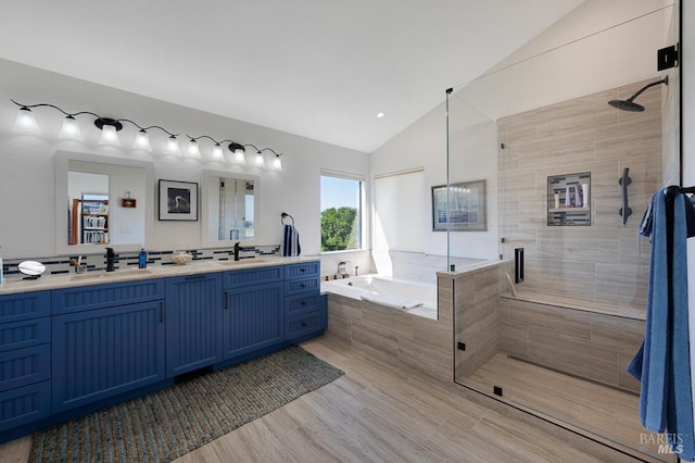 21199 Hummingbird Ct, Bodega Bay, CA 94923 - bathroom featuring vaulted ceiling, a shower stall, a garden tub, double vanity, and wood finished floors