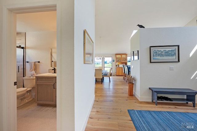 21199 Hummingbird Ct, Bodega Bay, CA 94923 - corridor featuring light wood-type flooring, a sink, and baseboards