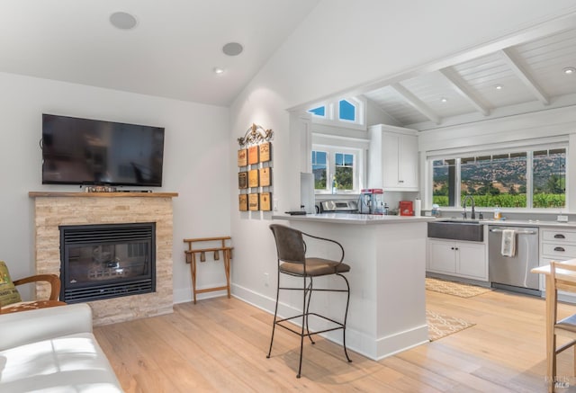 4223 Silverado Trl, Napa, CA 94558 - kitchen with stainless steel dishwasher, a sink, white cabinetry, and light wood-type flooring