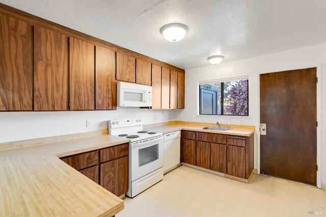 53 Monte Cresta Ave, Pleasant Hill, CA 94523 - kitchen with white appliances, light countertops, light flooring, a sink, and brown cabinets