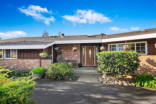 117 Farallon Dr, Vallejo, CA 94590 - property entrance with brick siding, board and batten siding, and a shingled roof