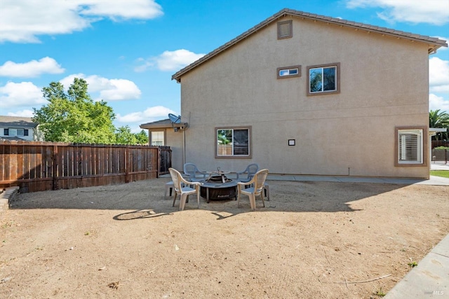 420 Georgetown Pl, Dixon, CA 95620 - rear view of house with stucco siding and a fire pit