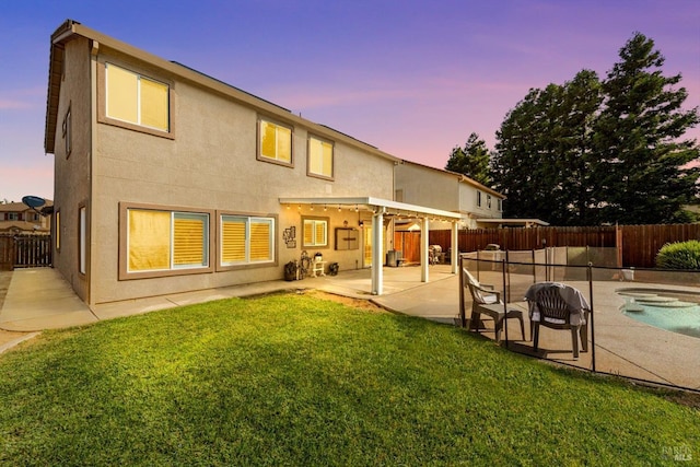 420 Georgetown Pl, Dixon, CA 95620 - back of property featuring a jacuzzi, a patio, and stucco siding