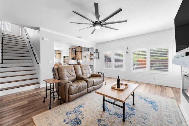 420 Georgetown Pl, Dixon, CA 95620 - living area featuring wood finished floors, a ceiling fan, a fireplace, stairs, and a textured ceiling