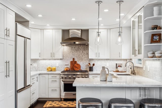 490 S Eliseo Dr, Greenbrae, CA 94904 - kitchen featuring wall chimney exhaust hood, high quality appliances, a peninsula, a kitchen bar, and white cabinets