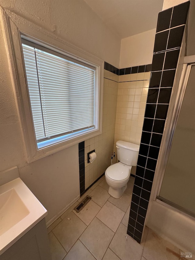 942 Benicia Rd, Vallejo, CA 94591 - full bath with toilet, an enclosed shower, tile patterned flooring, vanity, and tile walls