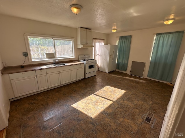 942 Benicia Rd, Vallejo, CA 94591 - kitchen with white appliances, a sink, under cabinet range hood, white cabinetry, and a textured ceiling
