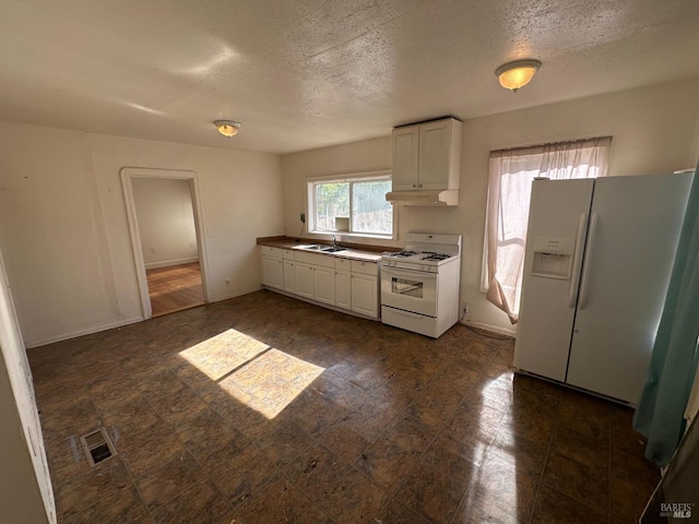 942 Benicia Rd, Vallejo, CA 94591 - kitchen featuring white appliances, a sink, a textured ceiling, white cabinets, and under cabinet range hood