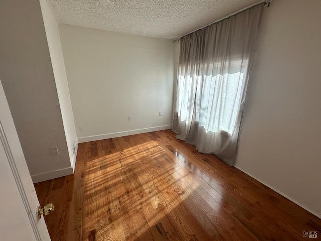 942 Benicia Rd, Vallejo, CA 94591 - unfurnished room featuring a textured ceiling, light wood-type flooring, and baseboards