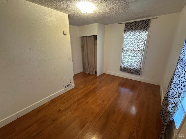 942 Benicia Rd, Vallejo, CA 94591 - unfurnished room with wood finished floors, baseboards, and a textured ceiling