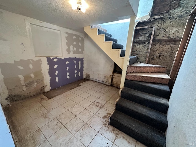 942 Benicia Rd, Vallejo, CA 94591 - basement featuring stairs, a textured ceiling, and light tile patterned floors