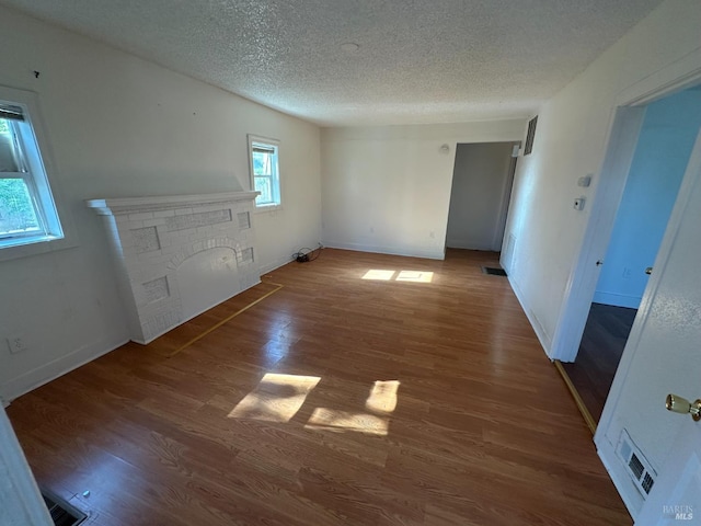 942 Benicia Rd, Vallejo, CA 94591 - unfurnished living room with a textured ceiling, wood finished floors, and baseboards