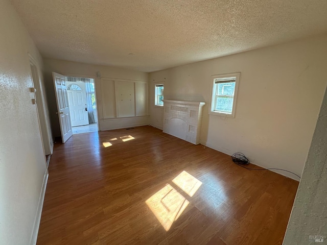 942 Benicia Rd, Vallejo, CA 94591 - entryway with a textured ceiling, wood finished floors, plenty of natural light, and a fireplace