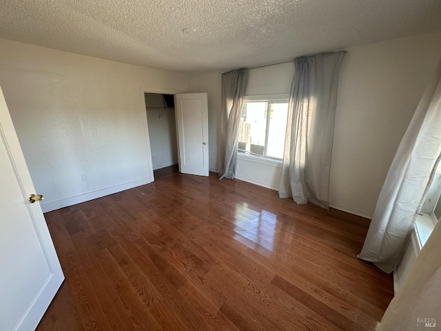942 Benicia Rd, Vallejo, CA 94591 - unfurnished bedroom with wood finished floors, a textured ceiling, baseboards, and a closet