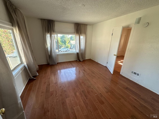 942 Benicia Rd, Vallejo, CA 94591 - empty room featuring a textured ceiling, wood finished floors, baseboards, and a smoke detector