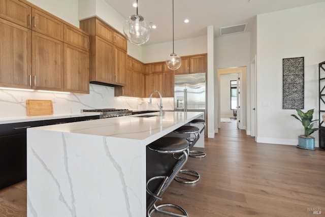 3704 Llyn Glaslyn Pl, Santa Rosa, CA 95403 - kitchen with a sink, stainless steel appliances, wood finished floors, a breakfast bar, and an island with sink