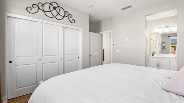 1212 Del Rancho Way, Petaluma, CA 94954 - bedroom with a closet, wood finished floors, ensuite bathroom, and a sink