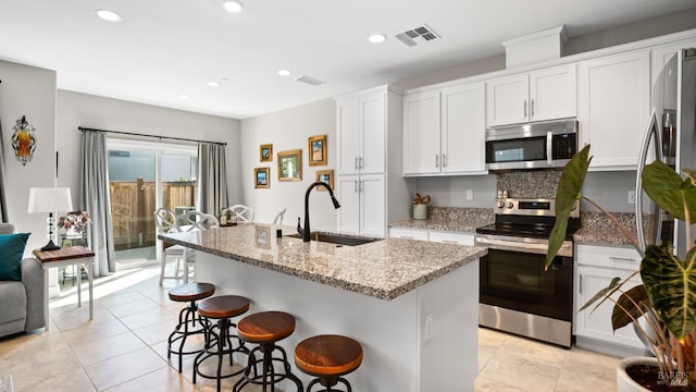 1212 Del Rancho Way, Petaluma, CA 94954 - kitchen with appliances with stainless steel finishes, a sink, light tile patterned floors, light stone counters, and recessed lighting