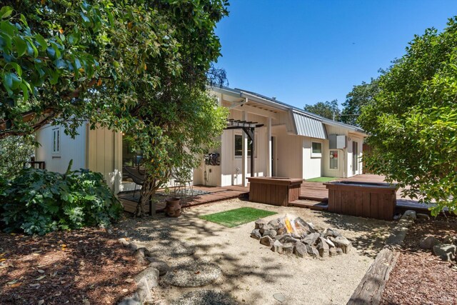 10 Waldruhe Hts, Glen Ellen, CA 95442 - back of house featuring an outdoor fire pit, a jacuzzi, and a patio