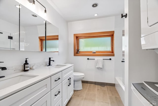 10 Waldruhe Hts, Glen Ellen, CA 95442 - bathroom featuring double vanity, toilet, stacked washer / dryer, baseboards, and shower / tub combination
