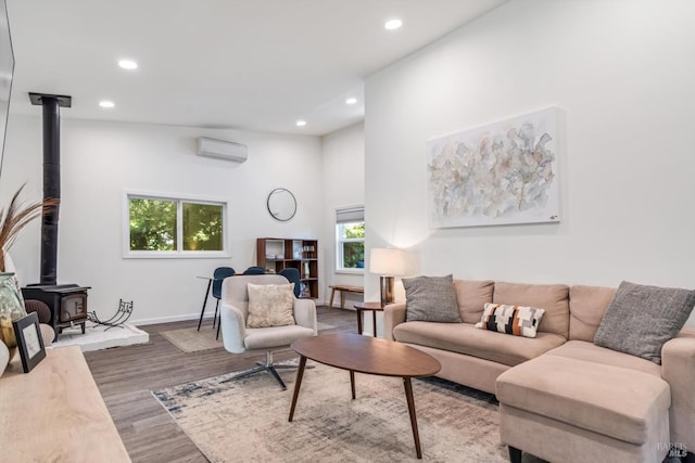 10 Waldruhe Hts, Glen Ellen, CA 95442 - living area featuring a wall mounted AC, a wood stove, wood finished floors, recessed lighting, and baseboards